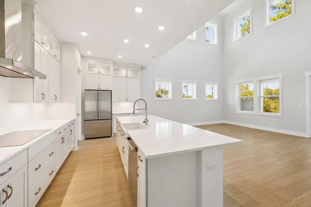 a view of large kitchen with stainless steel appliances kitchen island