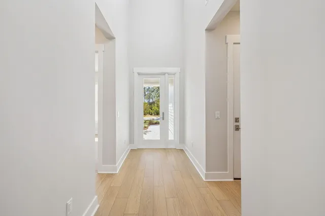 a view of a hallway with wooden floor and entryway