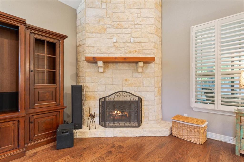 128 Creek Ridge Drive Waco, TX 76708 - Photo 11 of 40 Unfurnished living room featuring a stone fireplace, wood finished floors, and baseboards