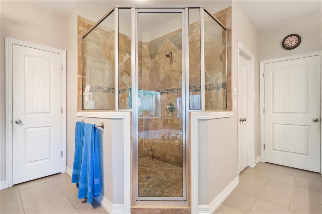128 Creek Ridge Drive Waco, TX 76708 - Photo 24 of 40 Full bath featuring tile patterned flooring, a shower stall, and baseboards