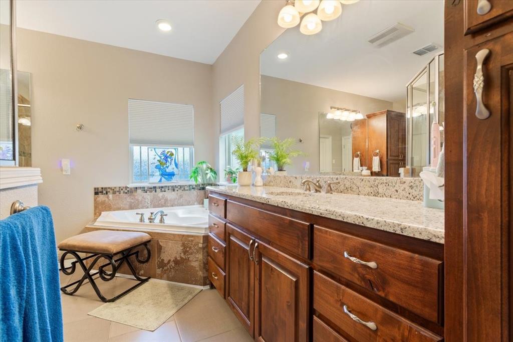 128 Creek Ridge Drive Waco, TX 76708 - Photo 25 of 40 Bathroom featuring vanity, a garden tub, and tile patterned floors