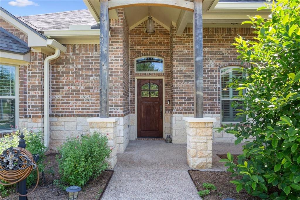 128 Creek Ridge Drive Waco, TX 76708 - Photo 6 of 40 Entrance to property featuring brick siding and a shingled roof