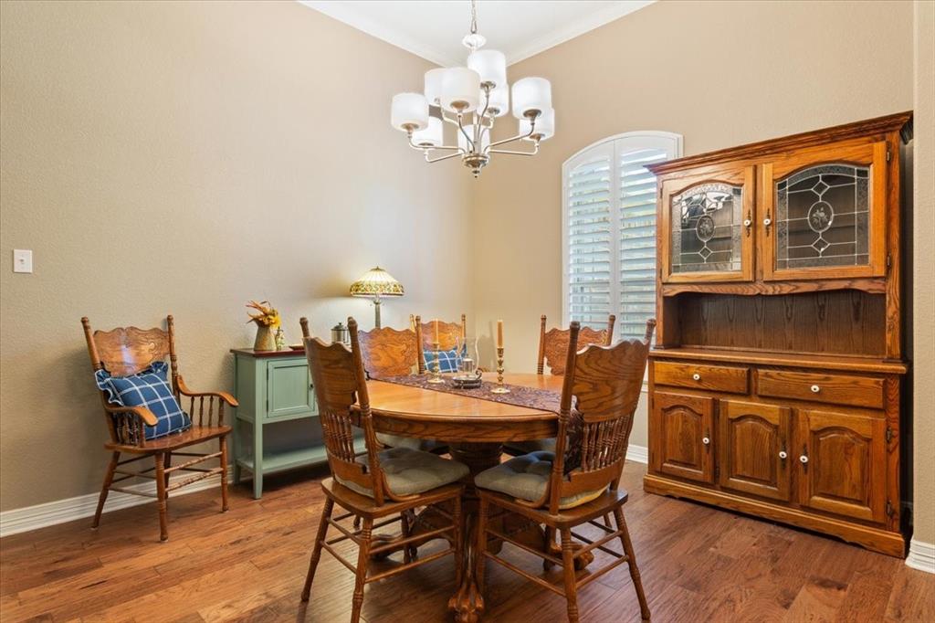 128 Creek Ridge Drive Waco, TX 76708 - Photo 8 of 40 Dining space with a chandelier, crown molding, wood finished floors, and baseboards