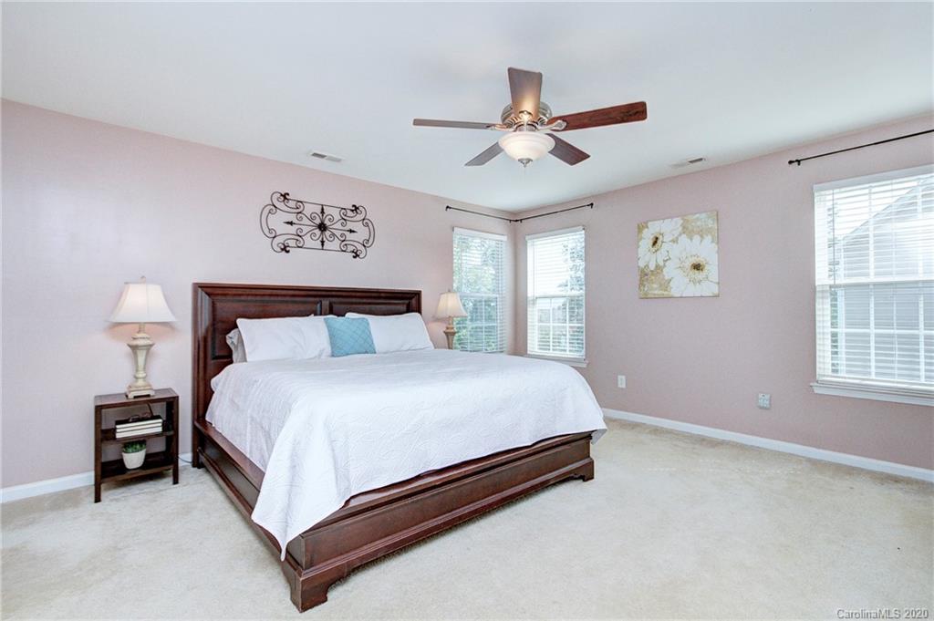 7029 Meyer Road Fort Mill, SC 29715 - Photo 22 of 42 a bedroom with a bed and a chandelier