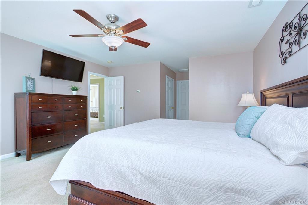 7029 Meyer Road Fort Mill, SC 29715 - Photo 23 of 42 a bedroom with a bed and a flat screen tv