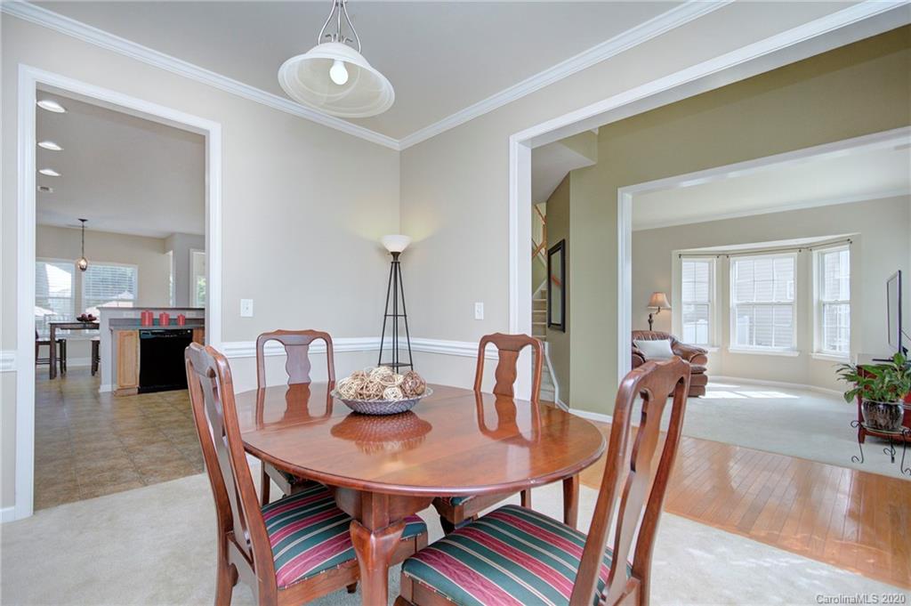 7029 Meyer Road Fort Mill, SC 29715 - Photo 8 of 42 a view of a dining room with furniture and wooden floor