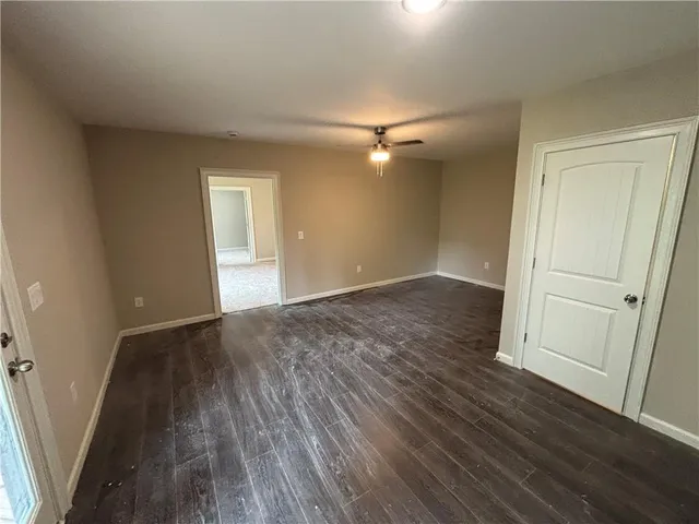 an empty room with wooden floor and entryway