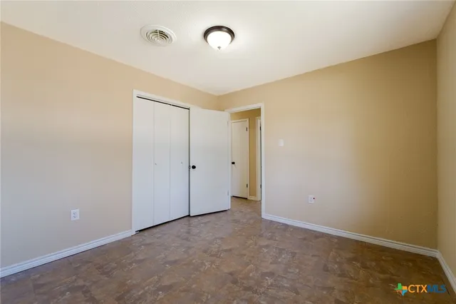an empty room with closet area