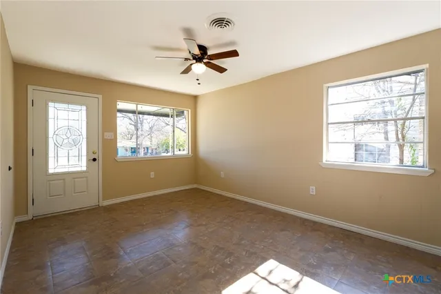 a view of an empty room with a window