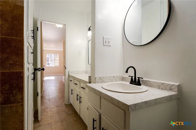 a kitchen with a sink cabinets and window