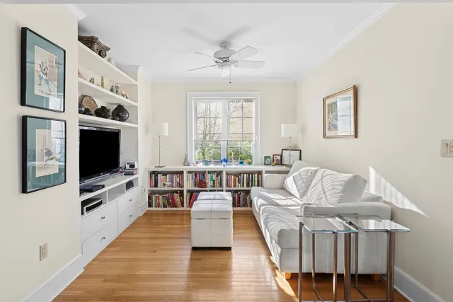 a living room with furniture wooden floor and flat screen tv
