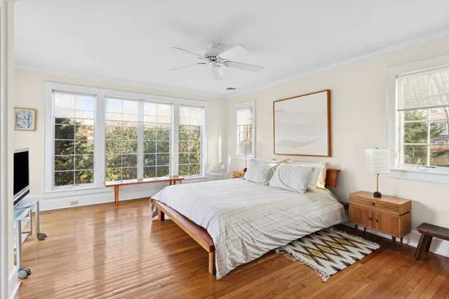 a bedroom with a large bed and a large window