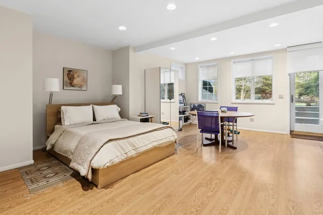 a spacious bedroom with a bed and a table in it