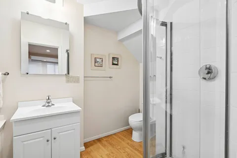 a bathroom with a sink a toilet and shower