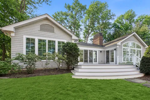 a front view of a house with a garden