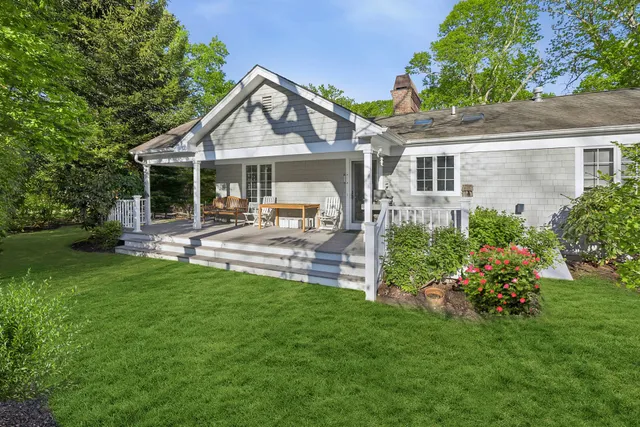 a front view of a house with a yard and sitting area