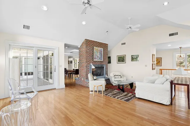 a living room with furniture and wooden floor