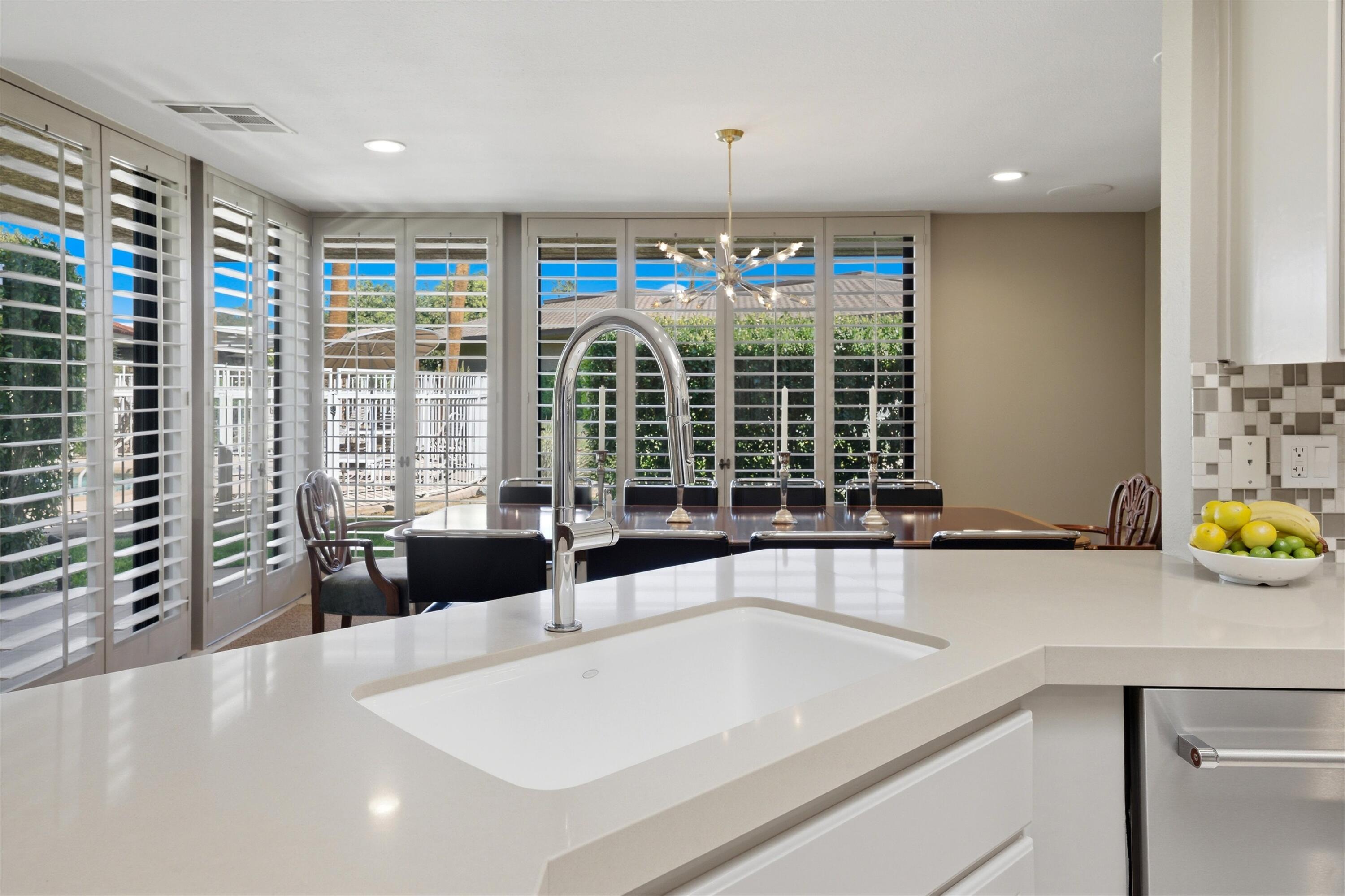 3 Barnard Court Rancho Mirage, CA 92270 - Photo 11 of 47 a view of a kitchen with a large window and furniture