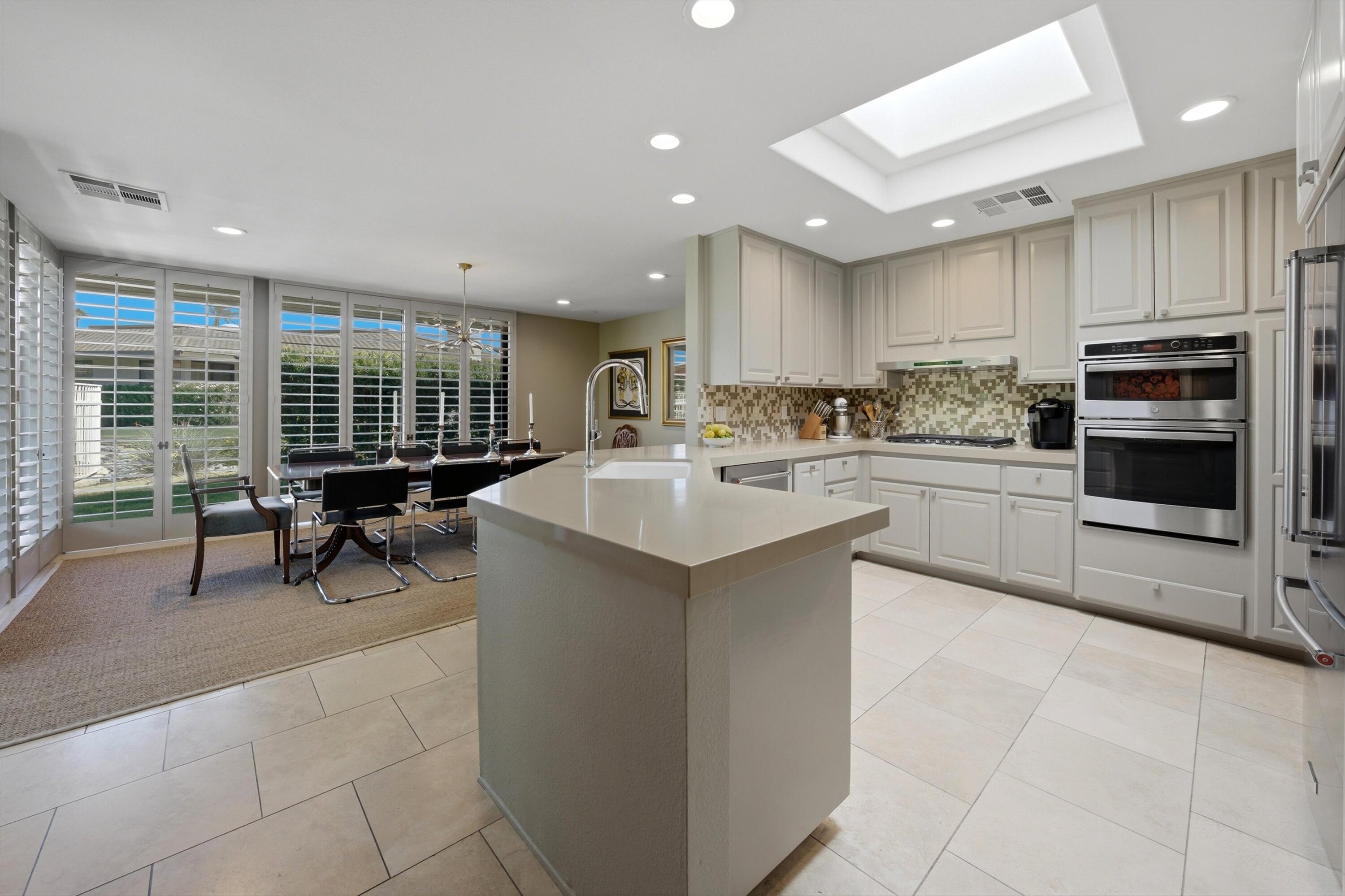 3 Barnard Court Rancho Mirage, CA 92270 - Photo 13 of 47 a kitchen with a sink stainless steel appliances and cabinets