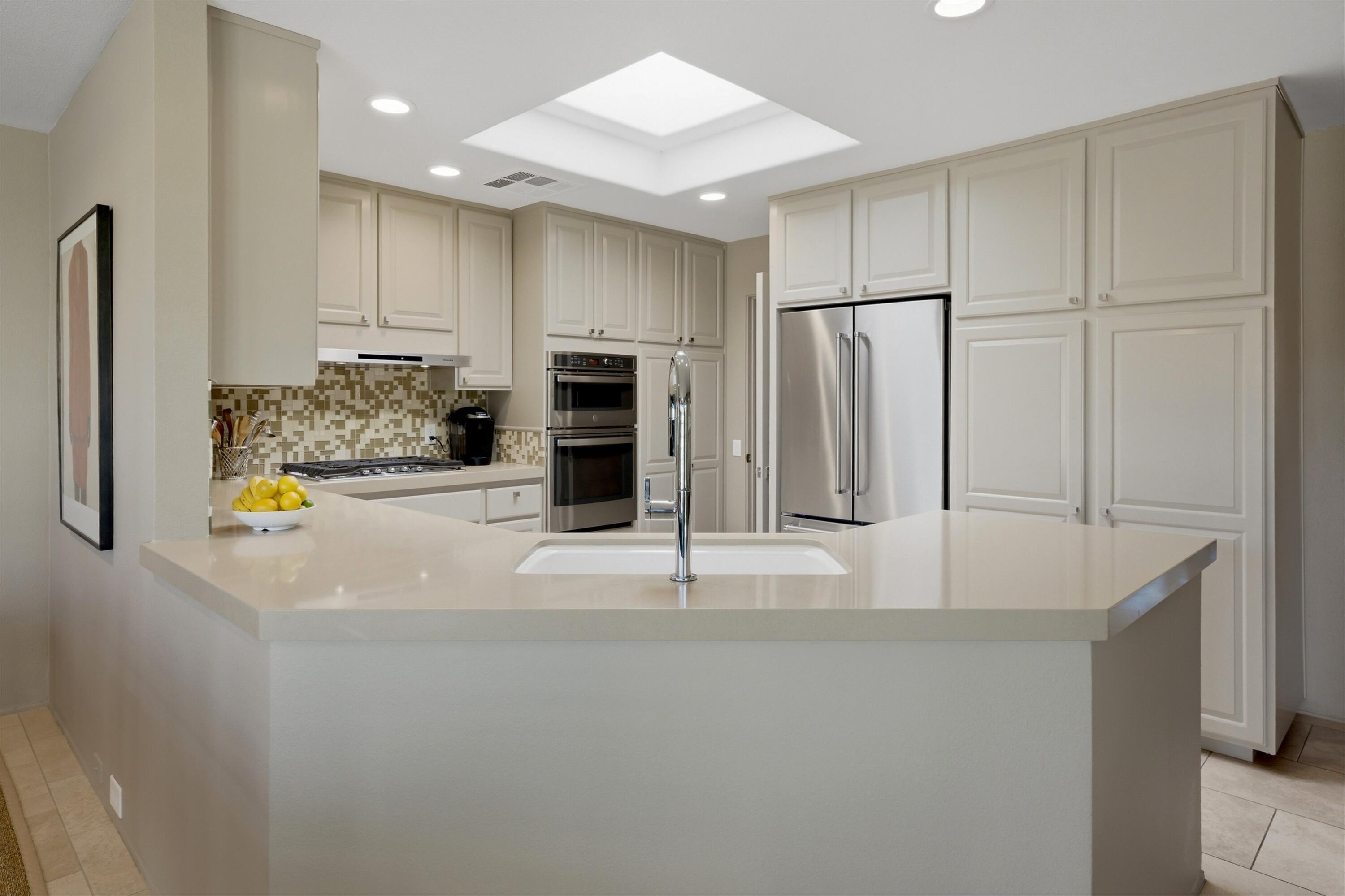 3 Barnard Court Rancho Mirage, CA 92270 - Photo 14 of 47 a view of kitchen with stainless steel appliances wooden floor and window