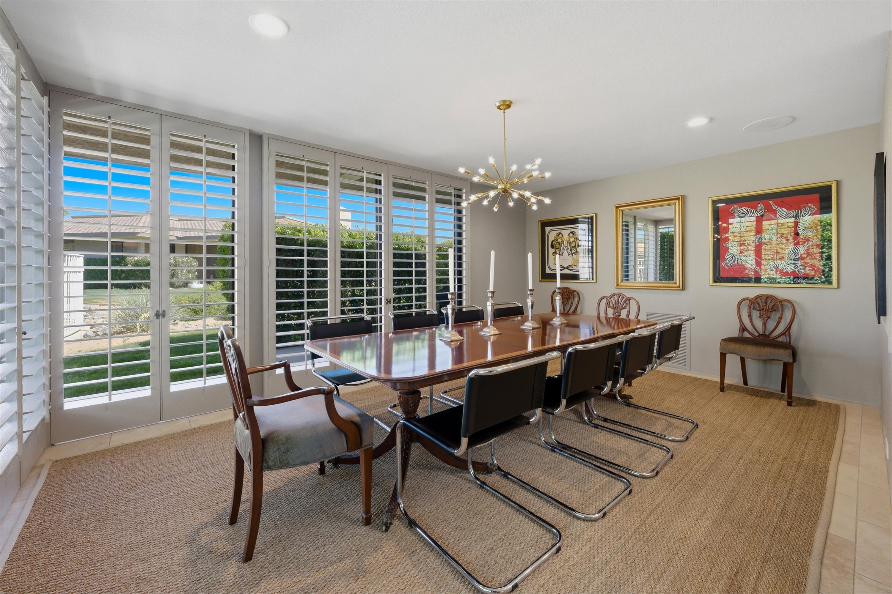 3 Barnard Court Rancho Mirage, CA 92270 - Photo 15 of 47 a room with lots of tables a large window and chairs
