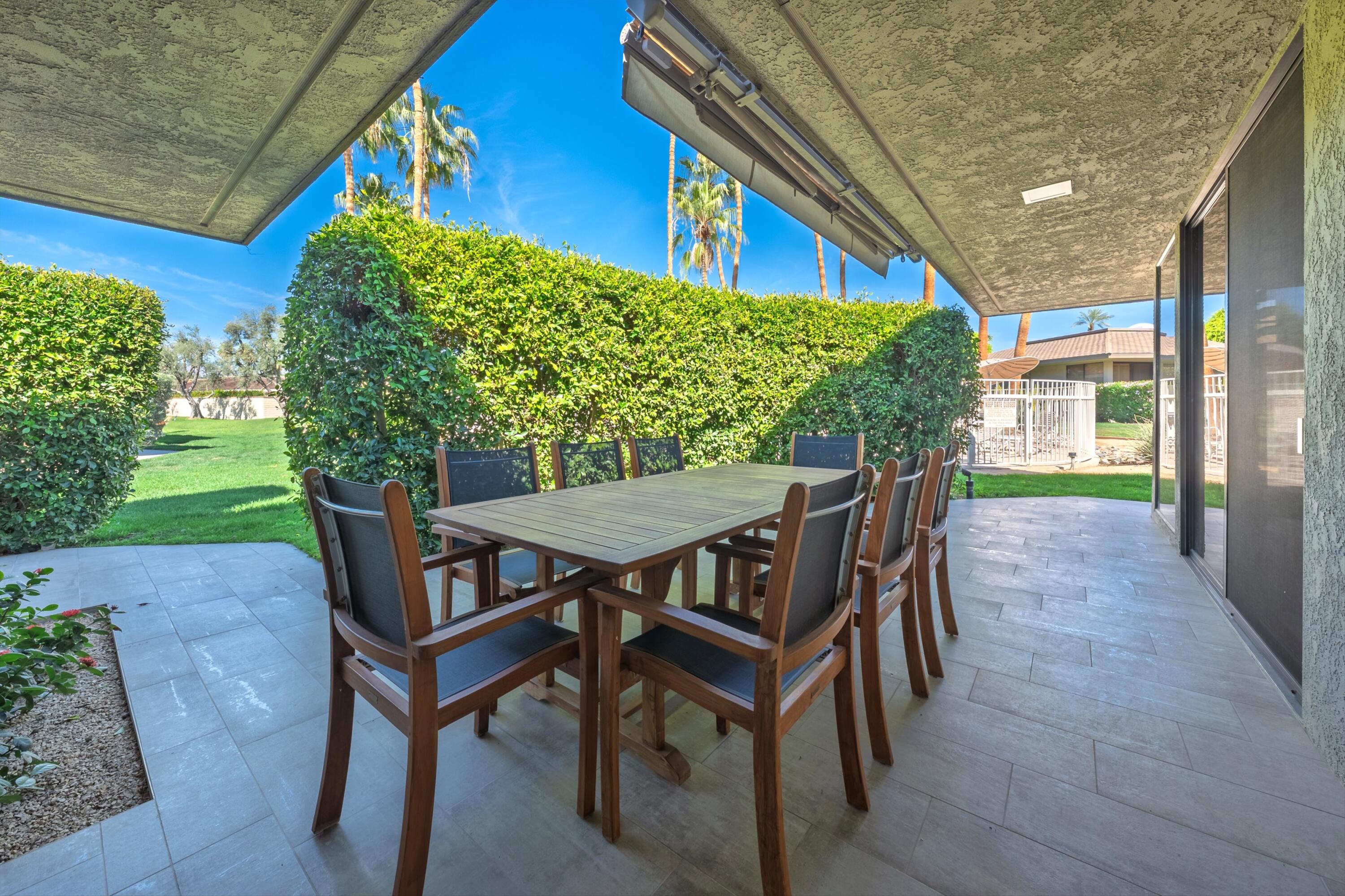 3 Barnard Court Rancho Mirage, CA 92270 - Photo 17 of 47 a view of a patio with table and chairs and potted plants