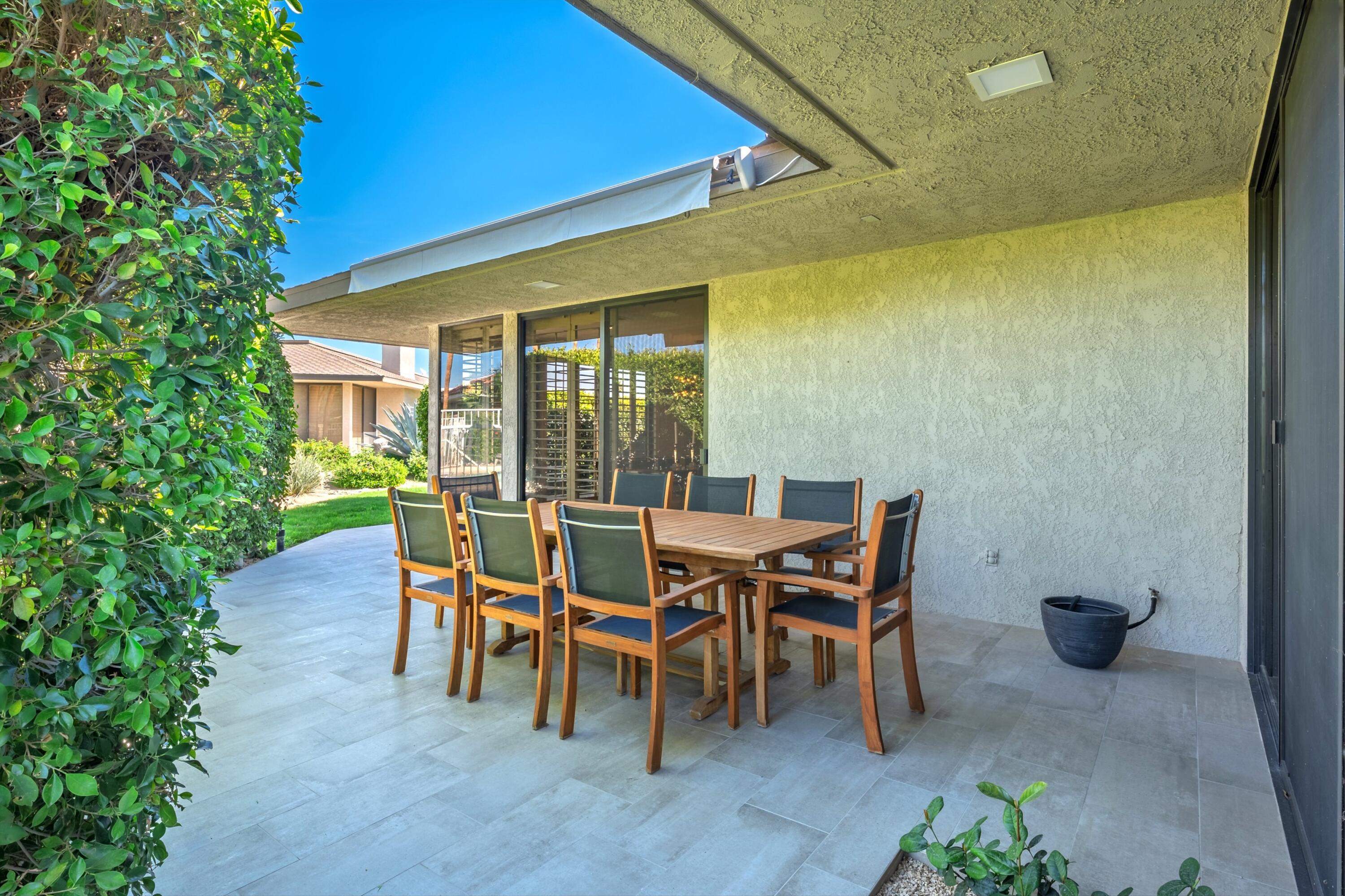3 Barnard Court Rancho Mirage, CA 92270 - Photo 18 of 47 a patio with table and chairs and potted plants
