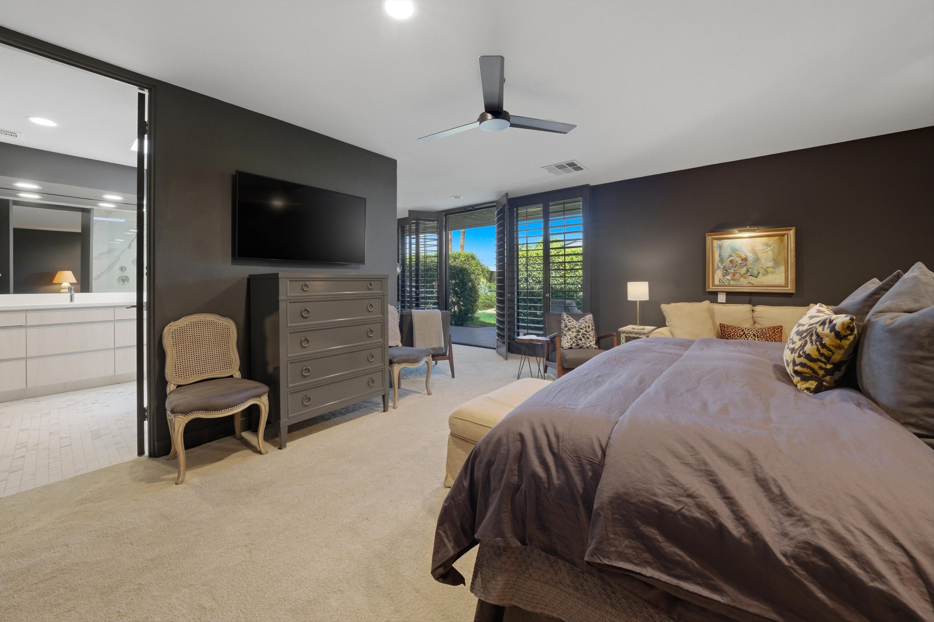 3 Barnard Court Rancho Mirage, CA 92270 - Photo 20 of 47 a bedroom with a bed a television and a large window