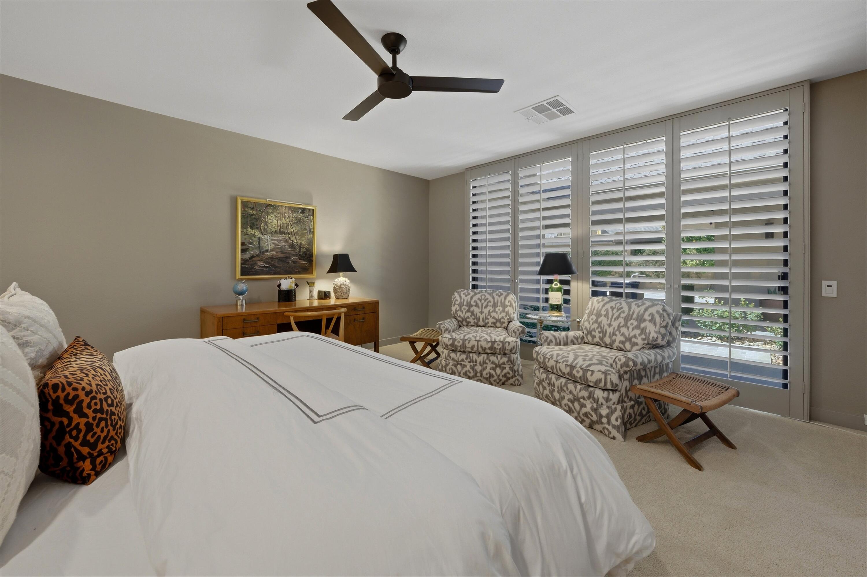 3 Barnard Court Rancho Mirage, CA 92270 - Photo 27 of 47 a bedroom with a bed a table and chair
