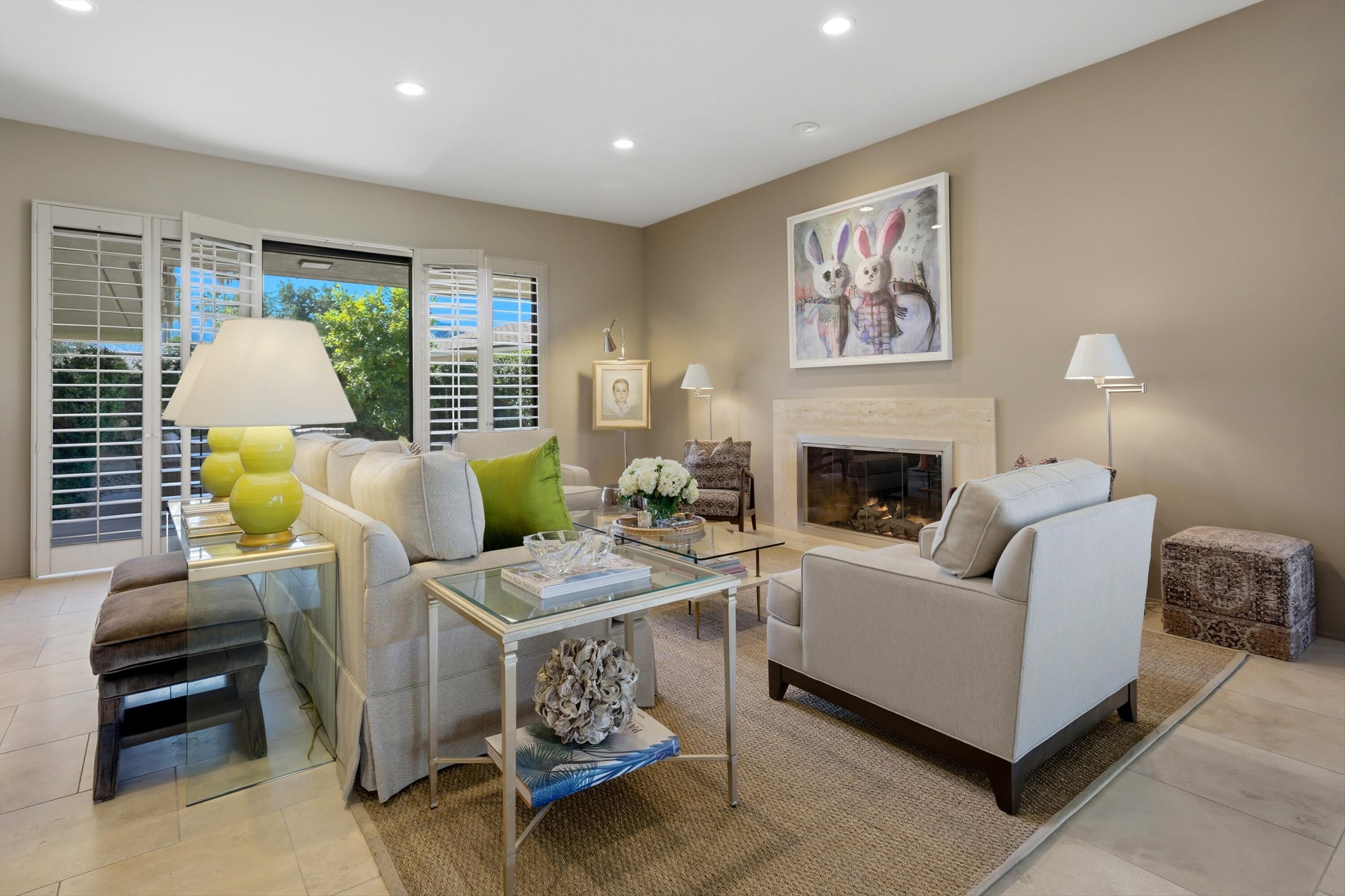 3 Barnard Court Rancho Mirage, CA 92270 - Photo 3 of 47 a living room with furniture and a fireplace