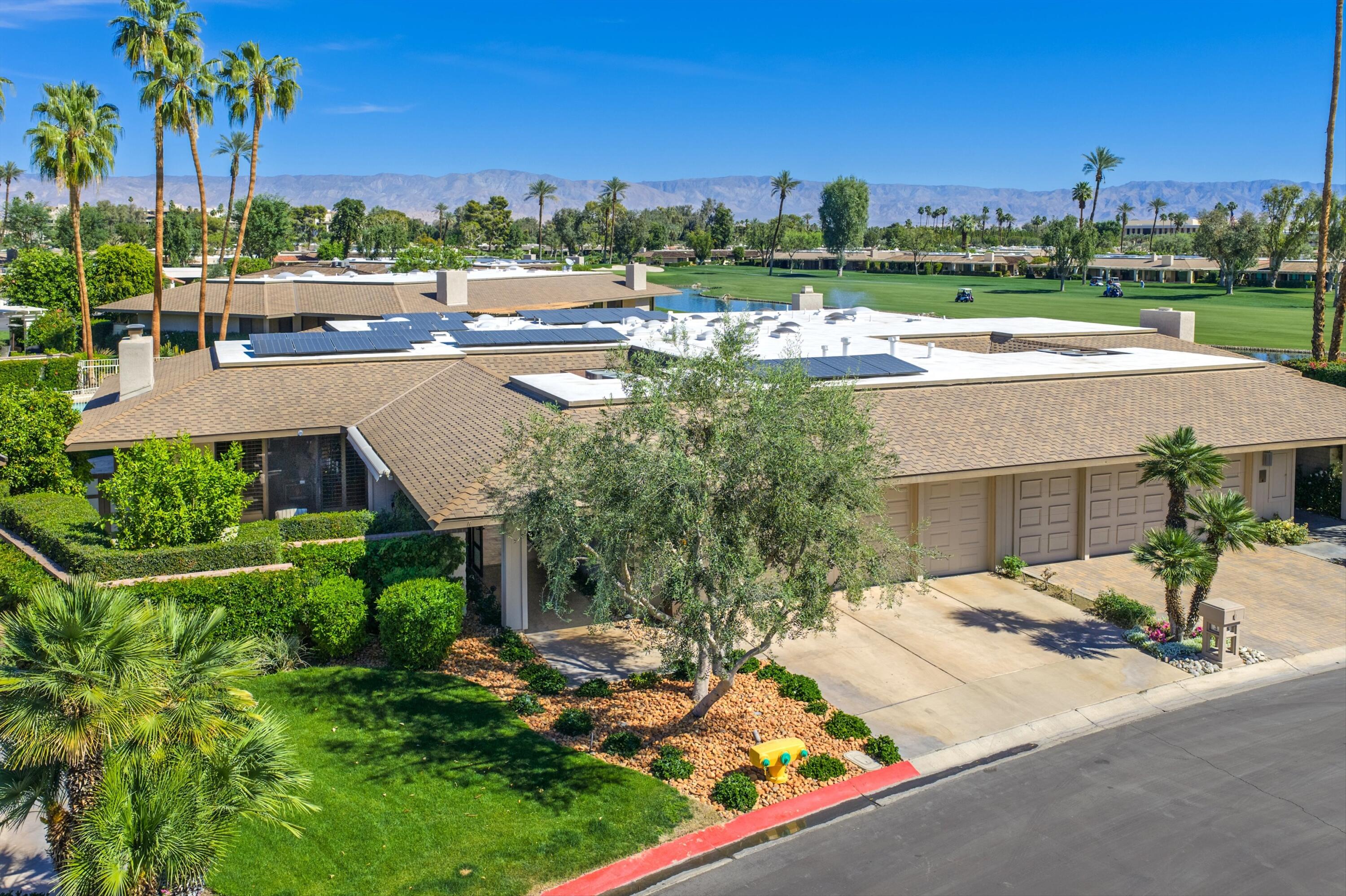 3 Barnard Court Rancho Mirage, CA 92270 - Photo 34 of 47 an outdoor view of a house with garden space and outdoor seating
