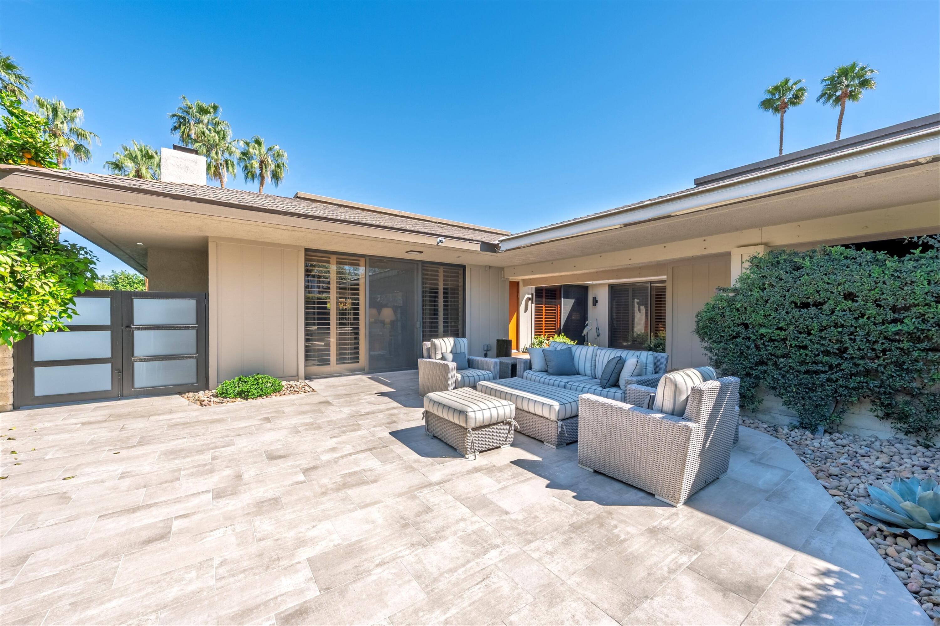 3 Barnard Court Rancho Mirage, CA 92270 - Photo 38 of 47 a house view with a seating space and garden