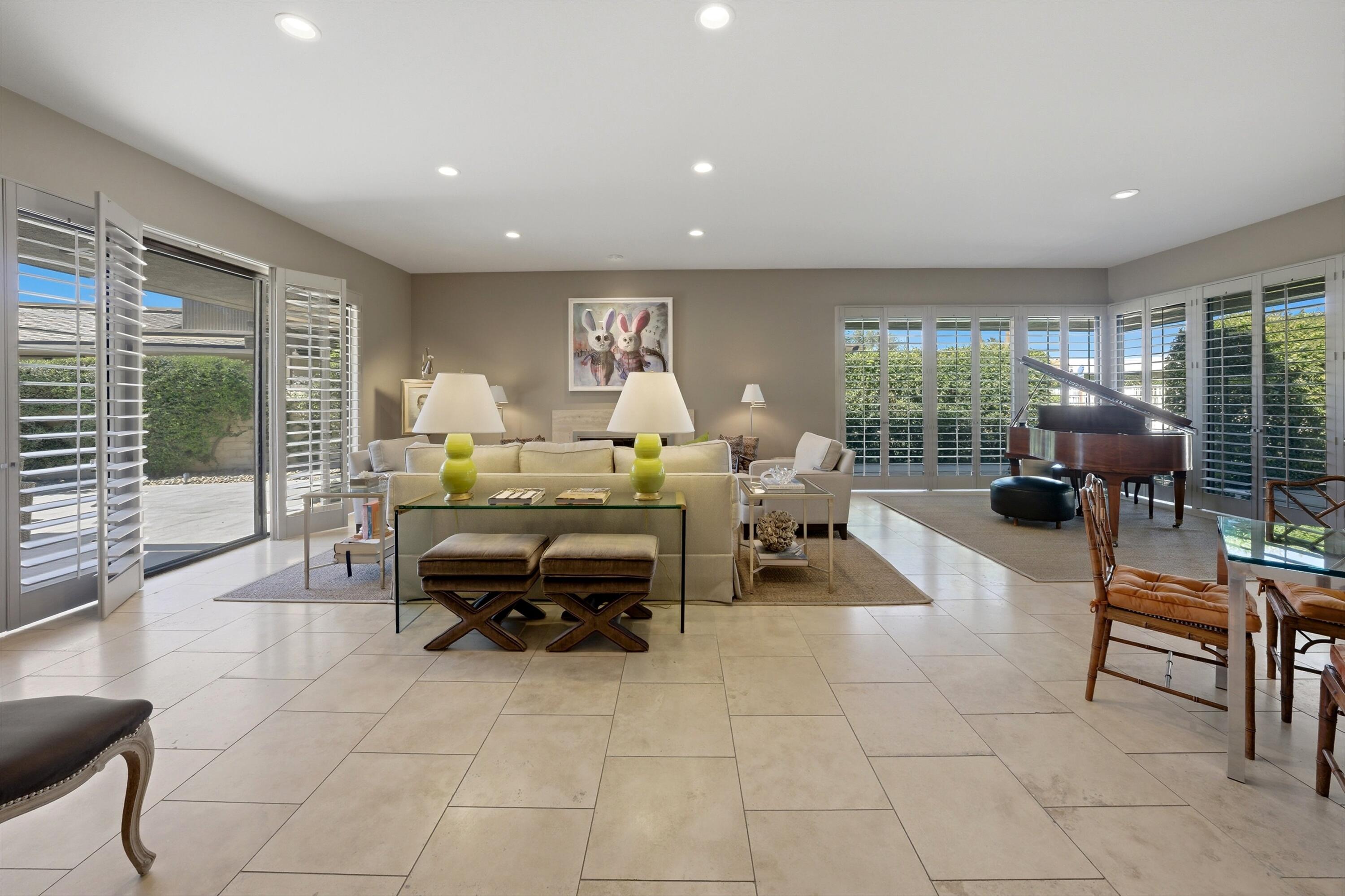 3 Barnard Court Rancho Mirage, CA 92270 - Photo 40 of 47 a living room with furniture a large window and kitchen view