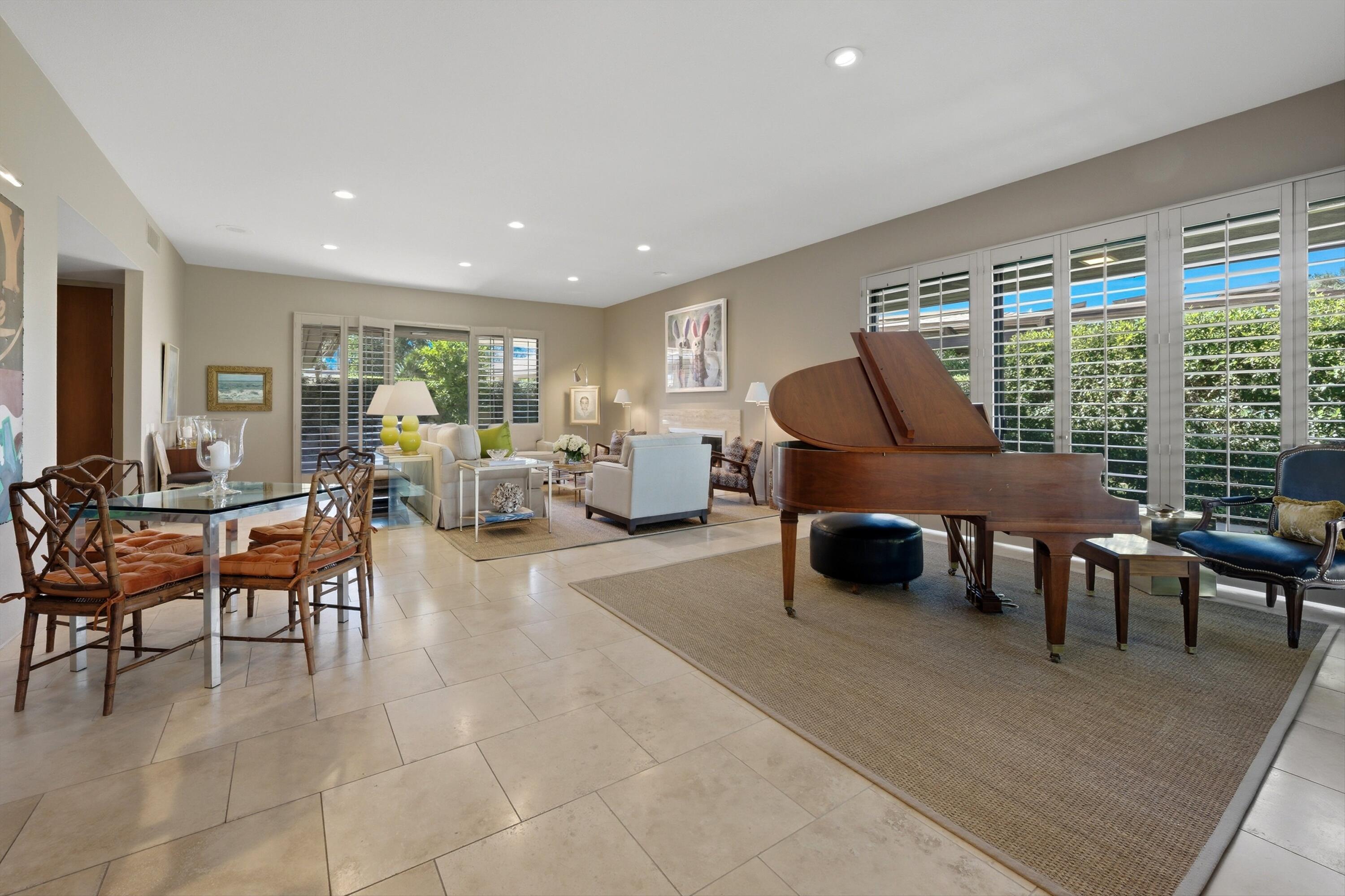 3 Barnard Court Rancho Mirage, CA 92270 - Photo 44 of 47 a living room with furniture a large window and chairs