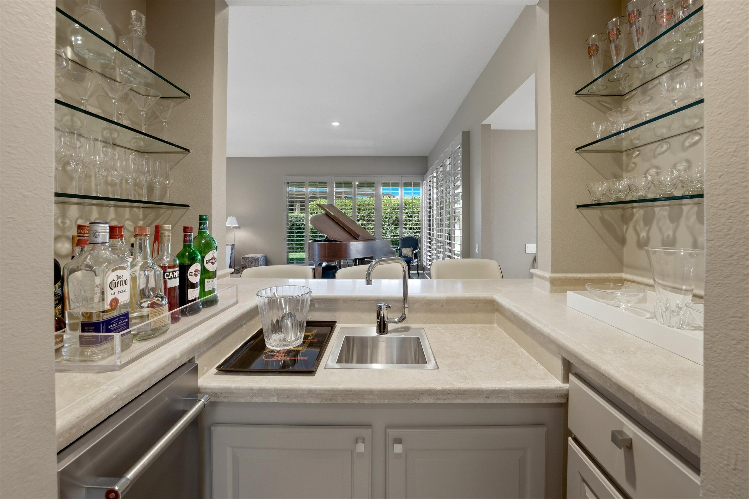 3 Barnard Court Rancho Mirage, CA 92270 - Photo 8 of 47 a view of a kitchen with a sink and dishwasher with wooden floor