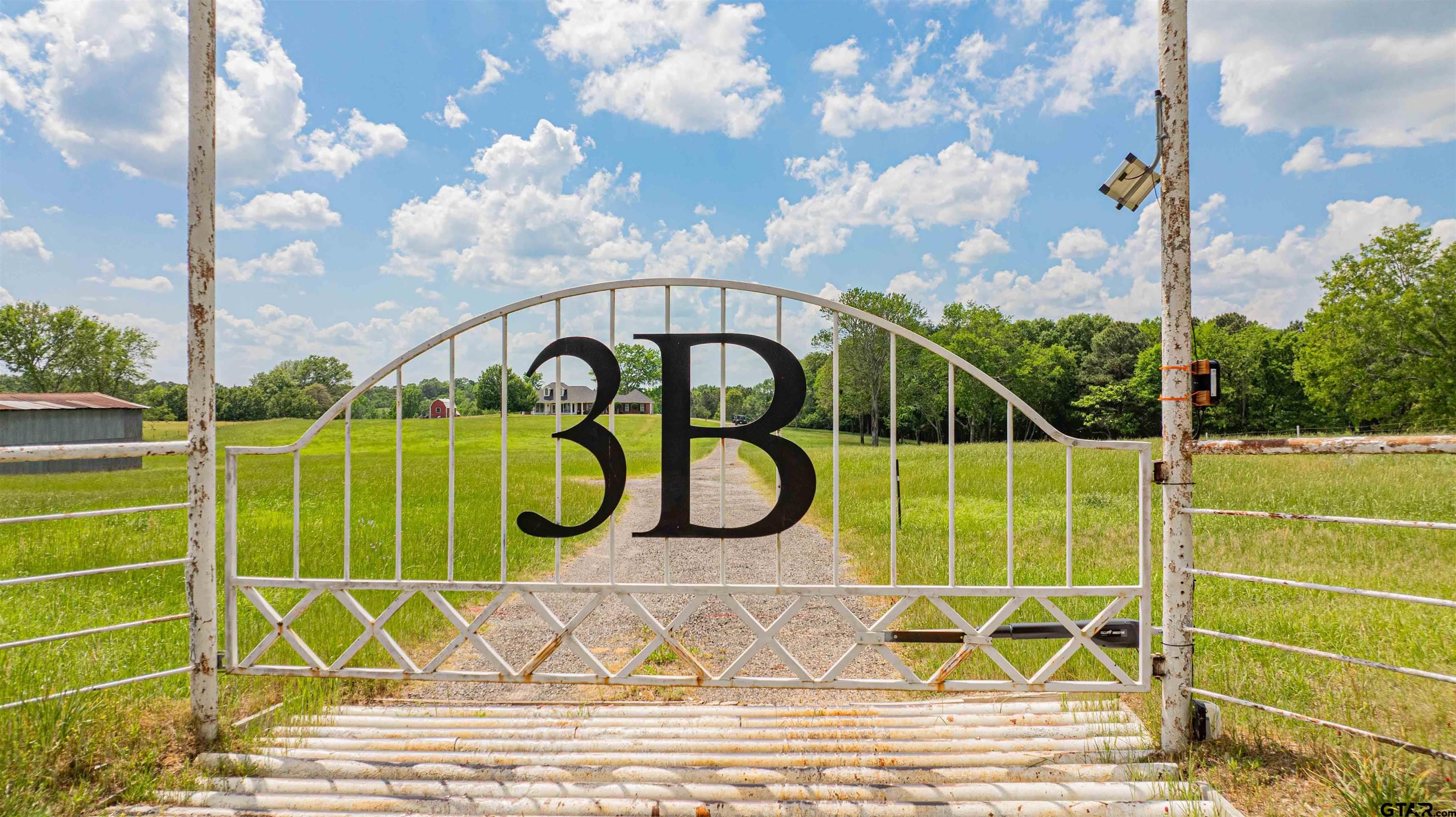 1855 Phillips Springs Road Gladewater, TX 75647 - Photo 20 of 36 a view of a tennis ground with a large pool