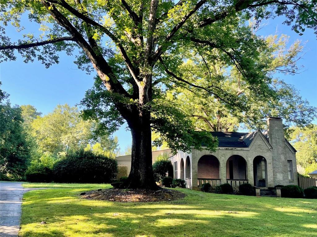 14 Mt Paran Road Northwest Sandy Springs, GA 30327 - Photo 1 of 1 a front view of a house with a garden and trees