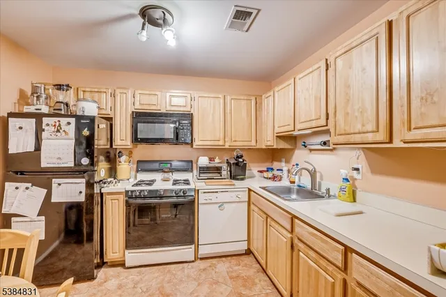 a kitchen that has a sink and a stove top oven