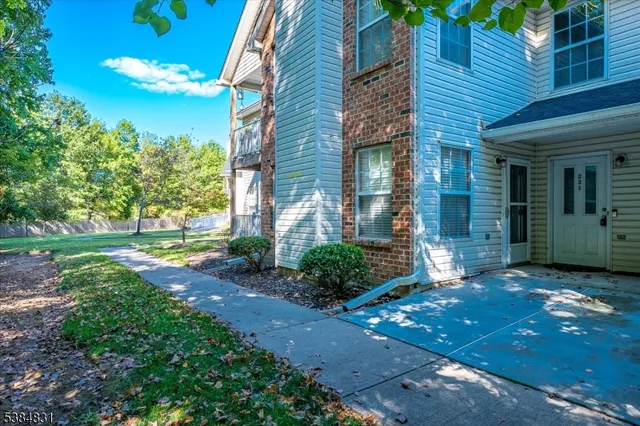 a view of a brick house with a yard