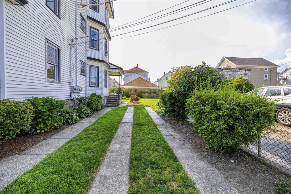 60 Murray Street Fall River, MA 02720 - Photo 25 of 35 a view of a white house with a yard and potted plants