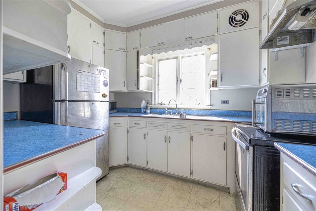 60 Murray Street Fall River, MA 02720 - Photo 3 of 35 a kitchen with a refrigerator sink and stove