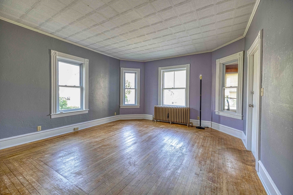 60 Murray Street Fall River, MA 02720 - Photo 9 of 35 an empty room with wooden floor and windows