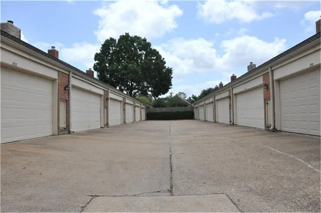 a view of a house with a backyard and garage