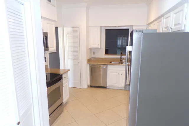 a kitchen with a refrigerator and a sink