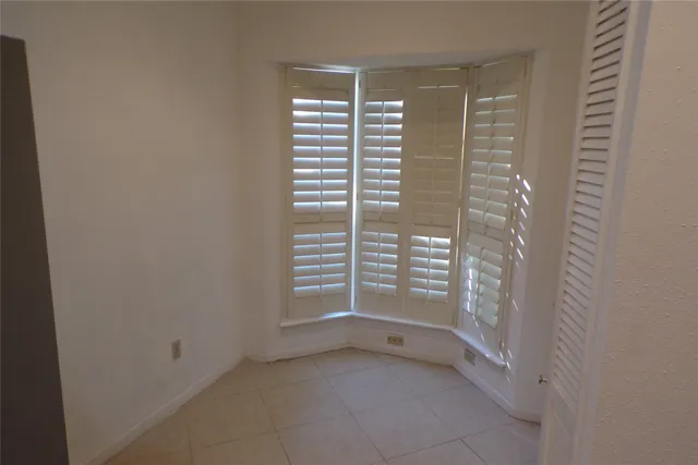 a view of a hallway with a chandelier fan