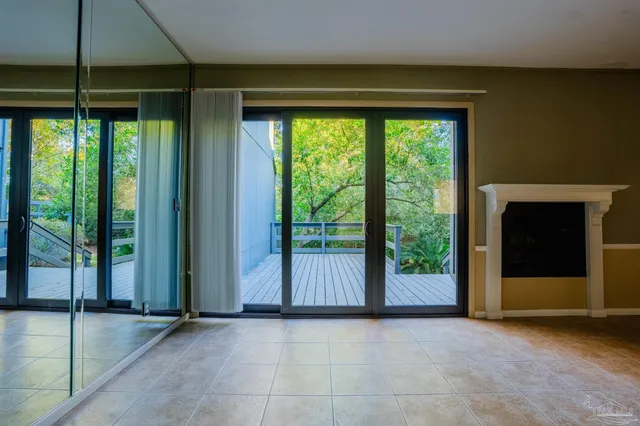 a view of a room with wooden floor and outdoor space