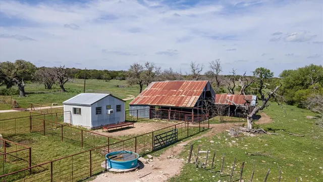 an aerial view of a house with swimming pool and furniture