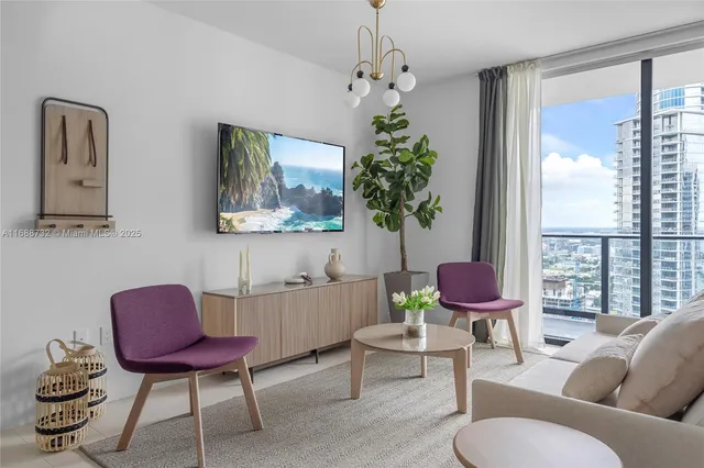 a living room with furniture and a potted plant