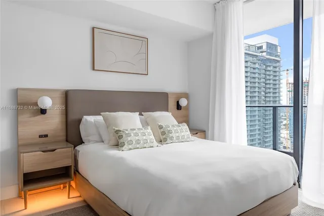 a bedroom with a bed and window