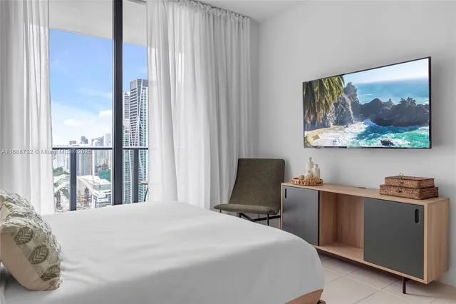 a bed sitting in a bedroom next to a window